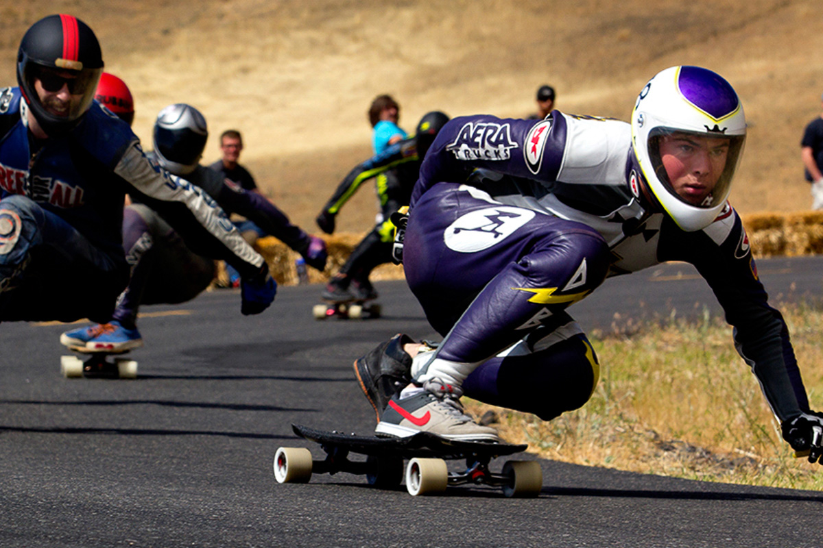 A determined longboard skateboarder rounds the corner during a race at the Maryhill Festival of Speed in eastern Washington