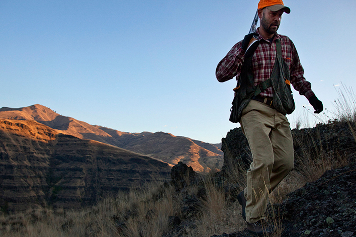 A bird hunter climbing a ridge in Eastern Oregon.