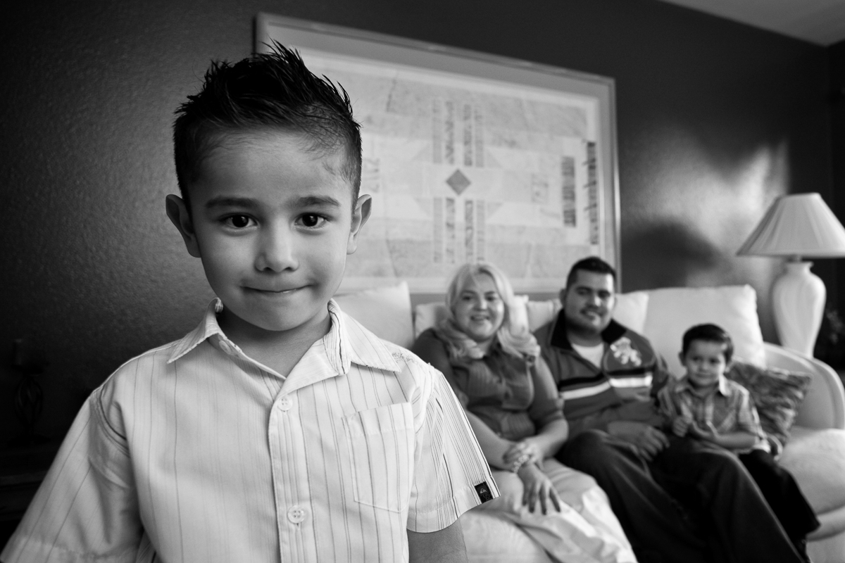 Hispanic boy with family in background